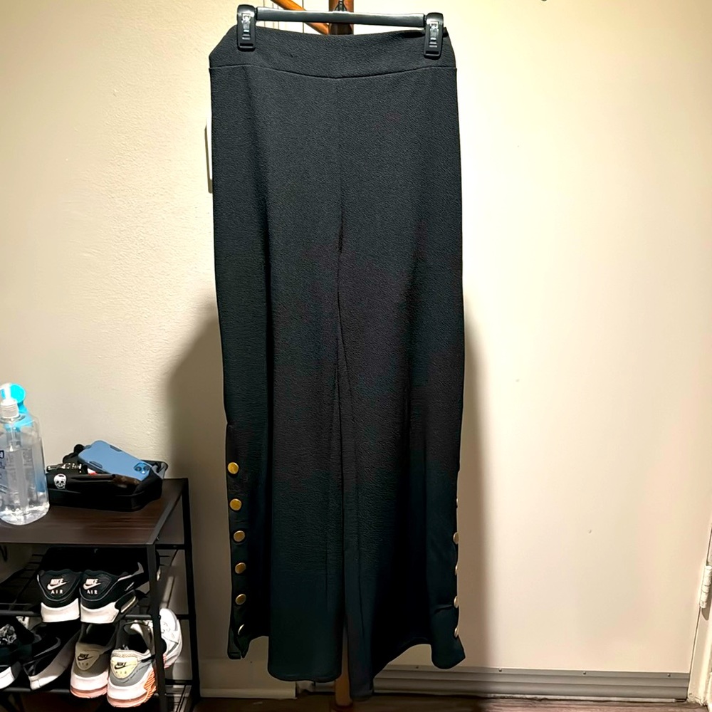 Brand new, high waisted, black wide leg trousers with rustic gold buttons.